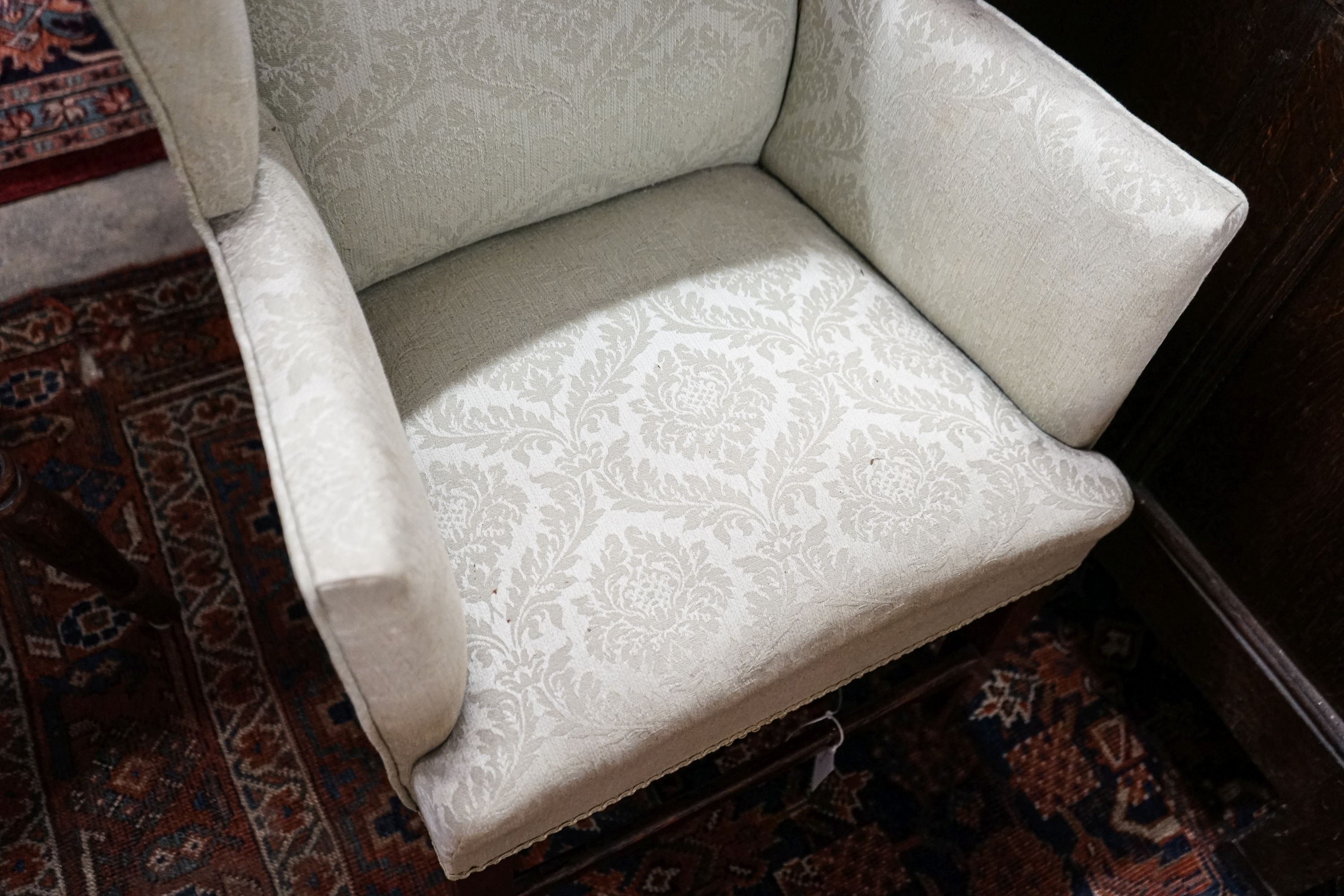A George III oak child's upholstered wing armchair, width 52cm, depth 41cm, height 84cm
